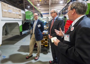 Motor Coach Industries plant manager Ron Storey (right) talks with Rep. Kevin Cramer (center) commerce department Commissioner Al Anderson (left) in Pembina during a recent event. Photo: North Dakota Department of Commerce