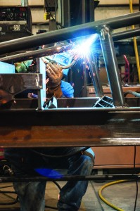 A welder manufactures product at L&H Industrial in Gillette, Wyoming. Locally owned L&H services mining, oil and gas, railroad and custom solutions clients with its six worldwide locations. Photo: Wyoming Business Council